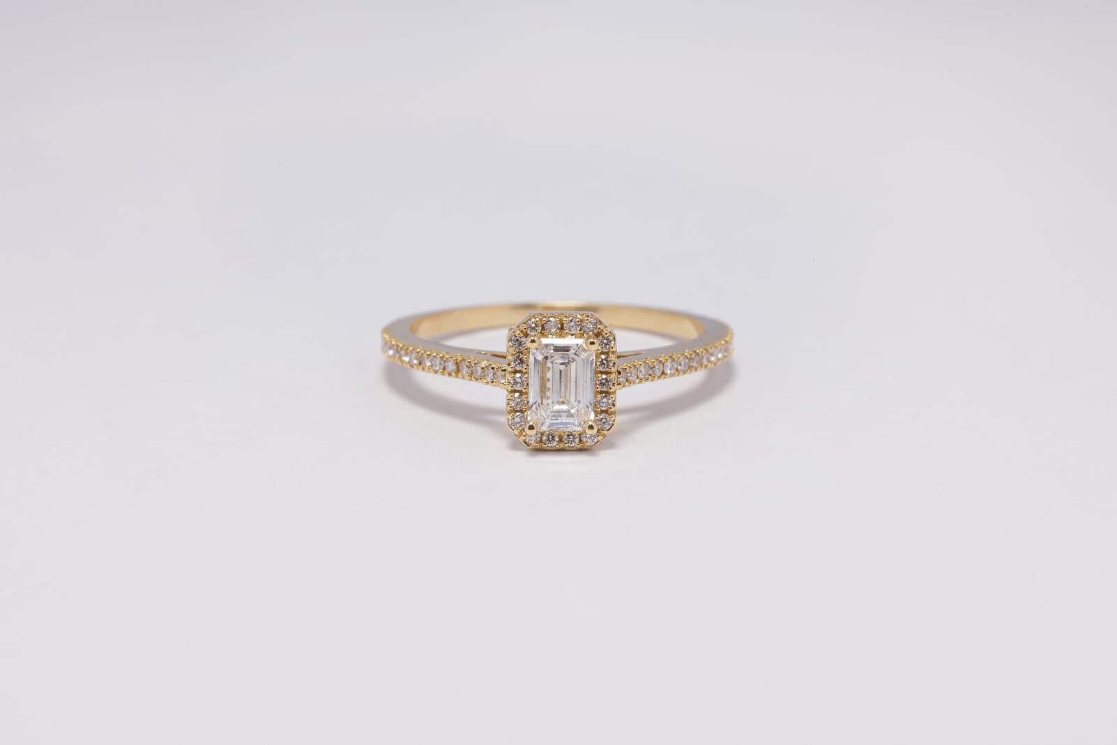 Handcrafted emerald cut shaped diamond with a halo
